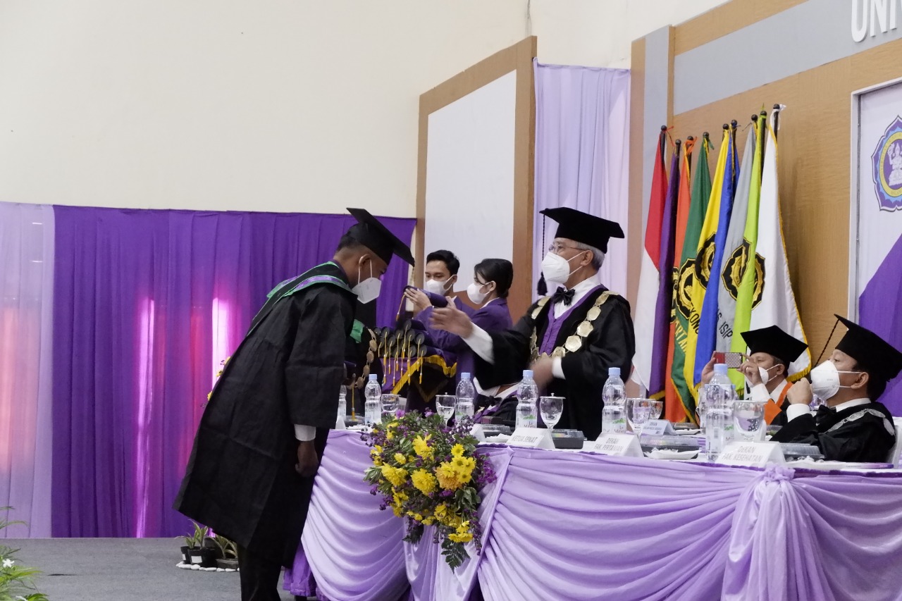 Rektor Unitri melakukan prosesi wisuda pada mahasiswa Unitri yang hadir secara luring. (Foto : Humas Unitri)