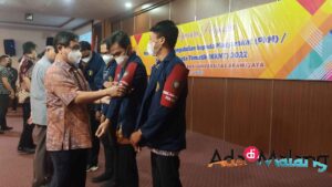 Dekan FIA UB, Drs. Andy Fefta Wijaya, MDA., Ph.D. memasang tanda Kordinator Kecamatan kepada mahasiswa peserta PKM/KKNT (Foto : Agus Y ~ AdaDiMalang.com)